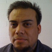 Man with short, spiky dark hair and goatee